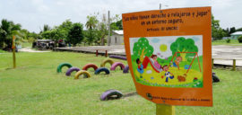 A sign at a sugar cane community in Belize reads 'Children have a right to relax and play in a safe environment'.